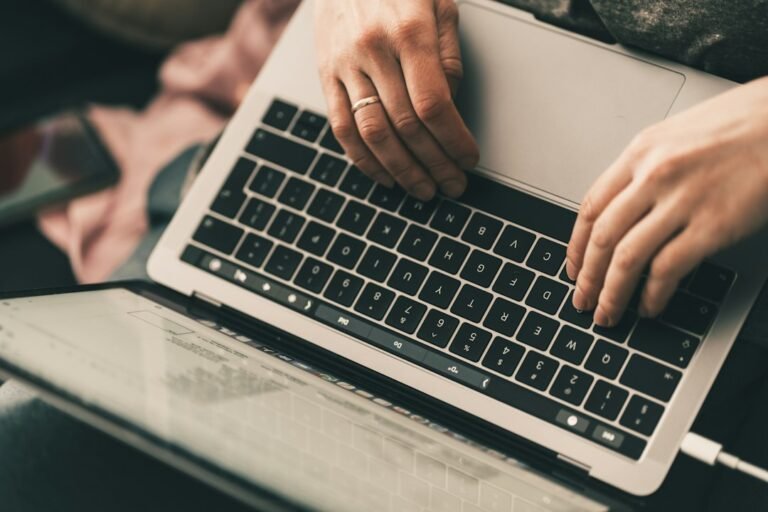 Person using a laptop while reviewing an accessible PDF document for screen reader use