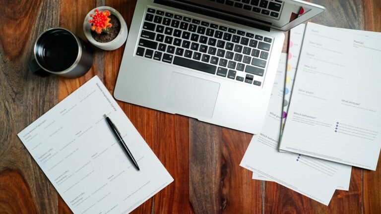Laptop and paperwork representing troubleshooting PDF text selection and copy problems